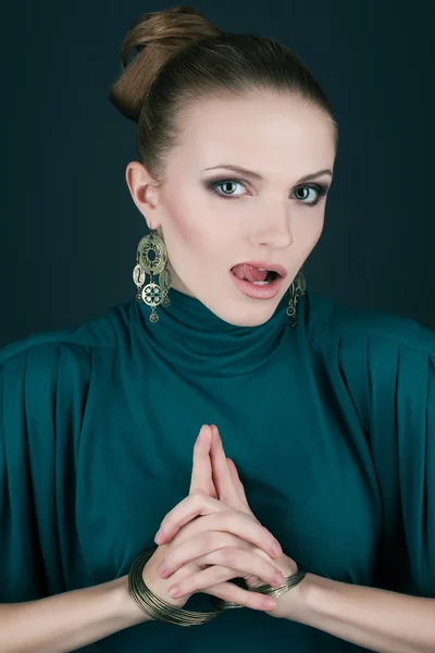 Uma bela jovem loira em um vestido verde (azul) usando wristba — Fotografia de Stock