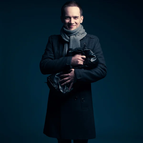 Portrait of a happy male buyer over dark blue background. studio — Stock Photo, Image