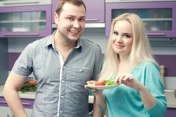 Portrait of a cute young couple standing in their well designed — Stock Photo, Image