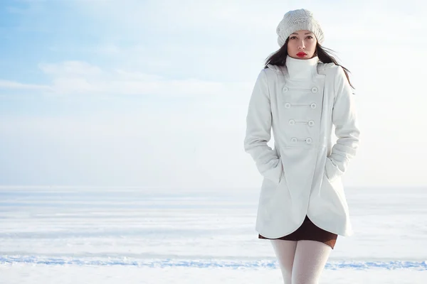 Emotive portrait of a fashionable model in white coat and beret — Stock Photo, Image