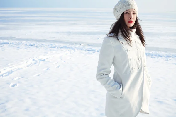 Emotive portrait of a fashionable model in white coat and beret — Stock Photo, Image