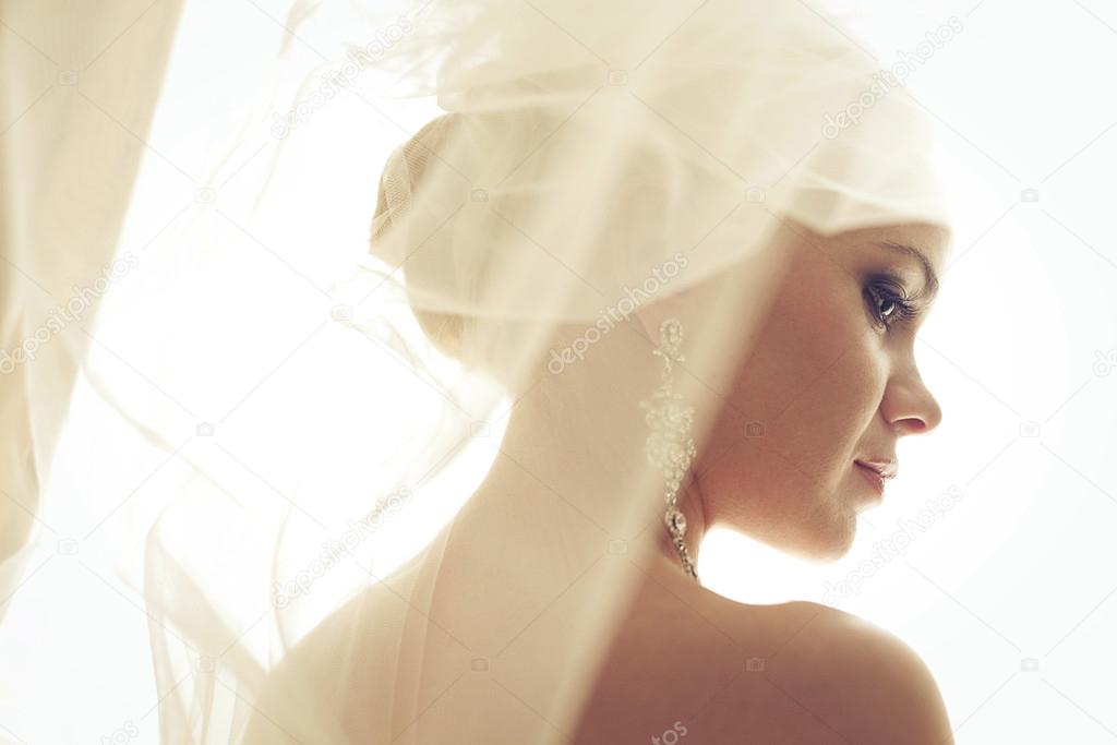 Portrait of a beautiful blonde bride. Wedding day. Daylight. Ind
