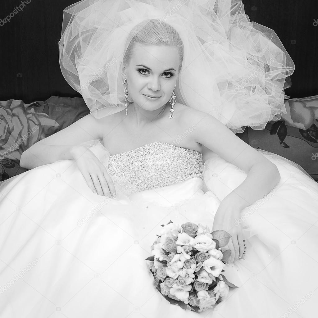 Portrait of a beautiful blonde bride with great vapory veil and