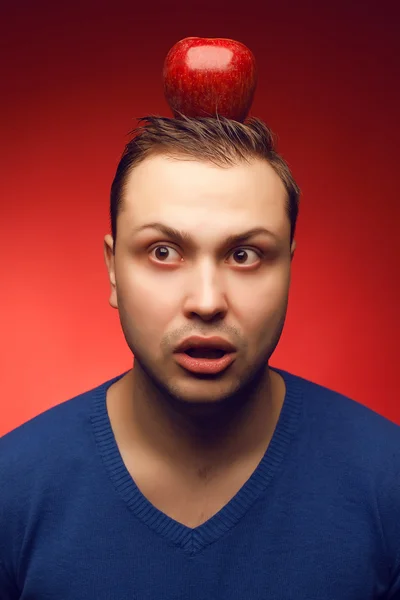 Portrait of funny and confused student guy posing over red backg — Stock Photo, Image