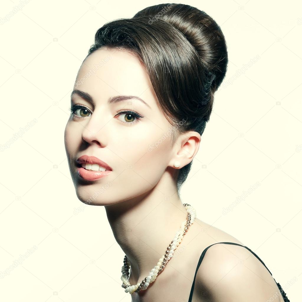 Retro portrait of a smiling beautiful woman with luxurious neckl
