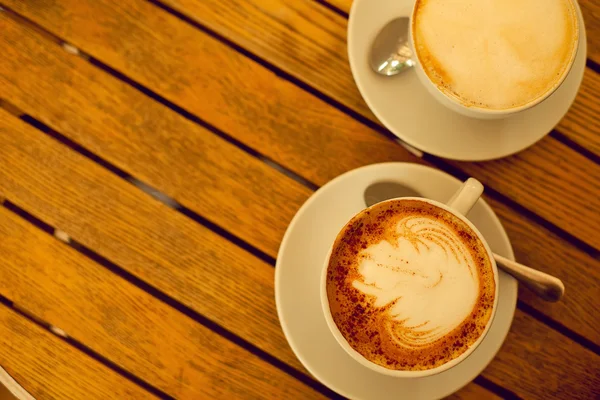 Latte art concept. Two cups with cappuccino (hot coffee with mil — Stock Photo, Image