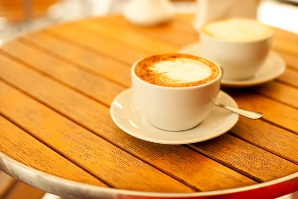 Latte art concept. Two cups with cappuccino (hot coffee with mil — Stock Photo, Image