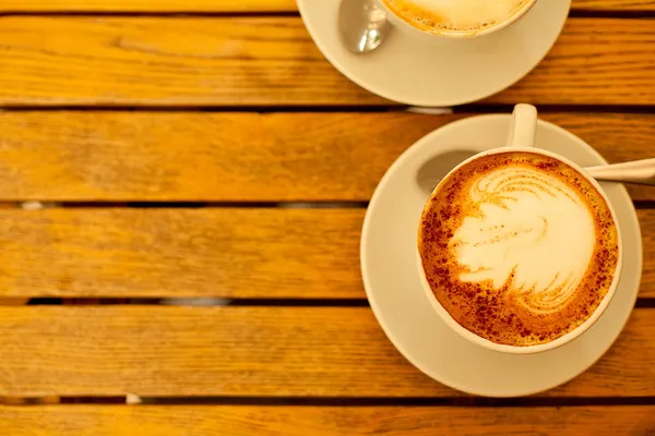 Latte art concept. Two cups with cappuccino (hot coffee with mil — Stock Photo, Image