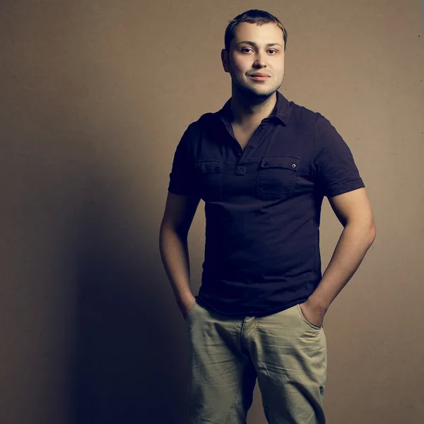 Portrait of smiling handsome young man isolated on wooden backgr — Stock Photo, Image