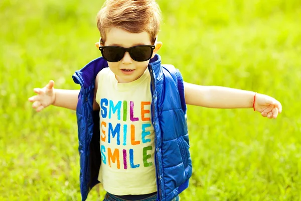 Stylish baby boy with ginger (red) hair in trendy sunglasses and — Stock Photo, Image