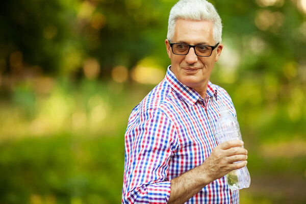 Portrait of a smiling happy mature (old) man in trendy casual sh