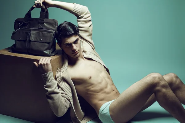 Concepto masculino de alta moda. Retrato de un guapo modelo masculino sentado — Foto de Stock