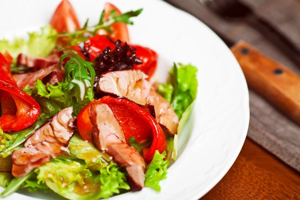 Sappige sappige gedeelte van warme salade met gegrilde steaks — Stockfoto
