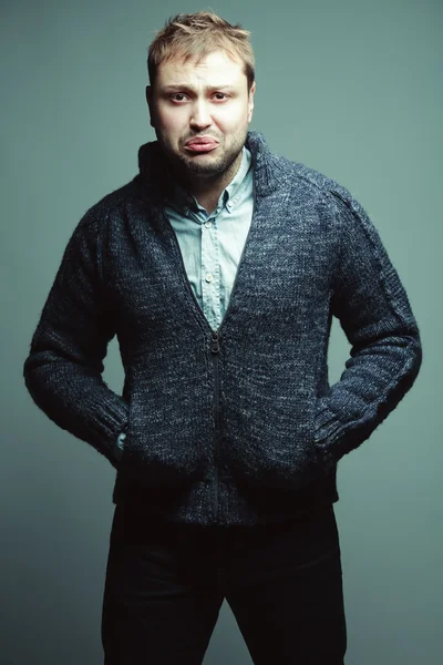 Funny portrait of a handsome unhappy young man in casual trendy — Stock Photo, Image