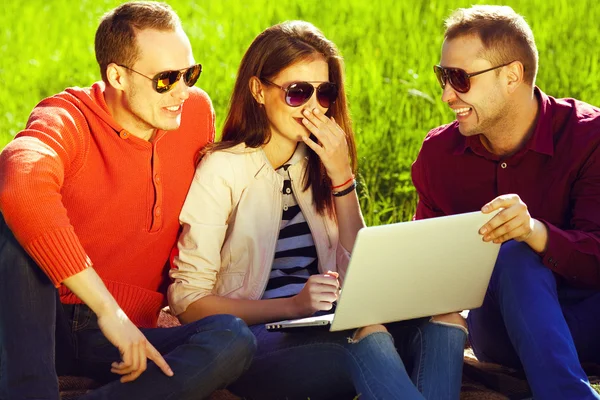 Useful weekend concept. Three happy friends having fun in park — Stock Photo, Image