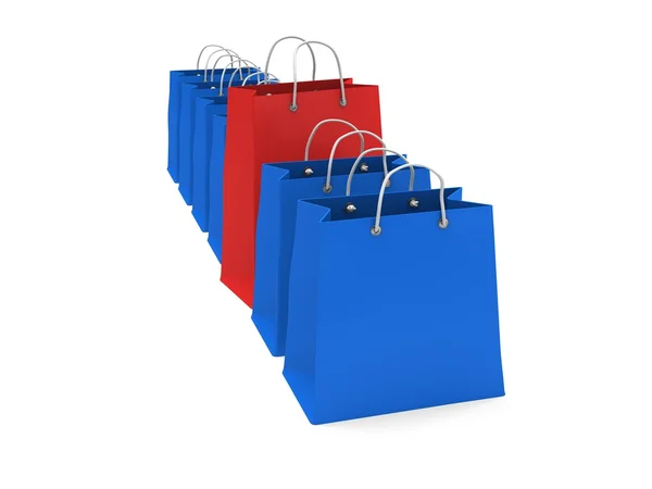 Rote Einkaufstasche in einer Reihe blauer Taschen — Stockfoto