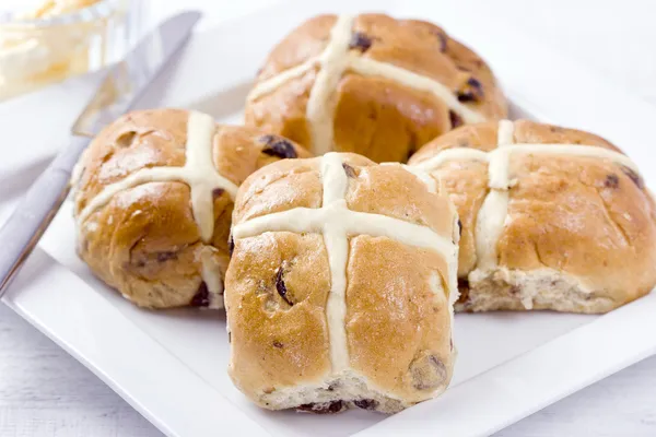 Hot Cross Buns With Butter On A White Plate.