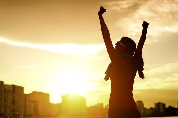 Happy successful sportswoman raising arms — Stok fotoğraf