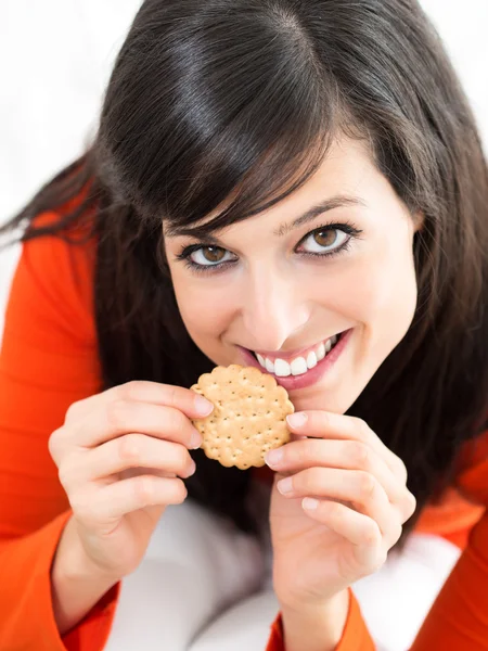 Woman eating cracker — Stock Photo, Image