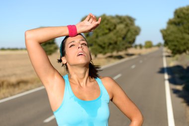 Tired woman sweating after running clipart