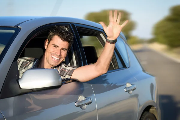 Man driving car on road Stock Image