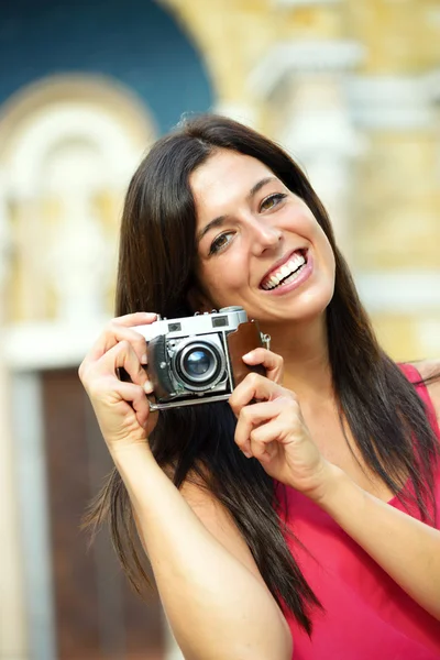 Woman with camera taking photo — 图库照片