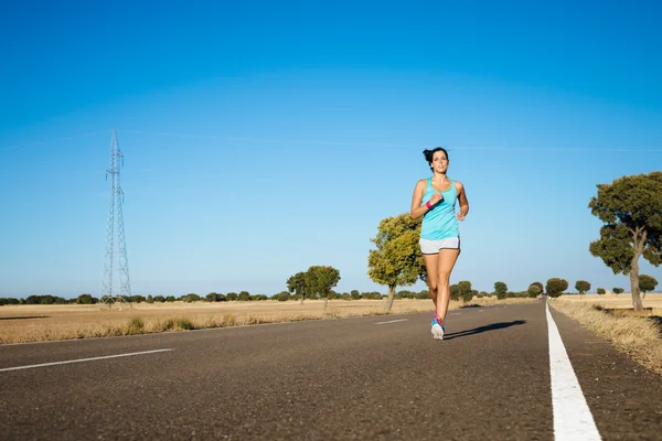 Fitness sporty woman running on road — Stock Photo, Image