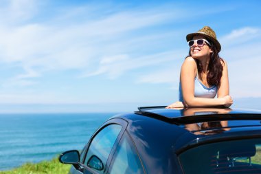 Woman on summer vacation leaning out sunroof clipart