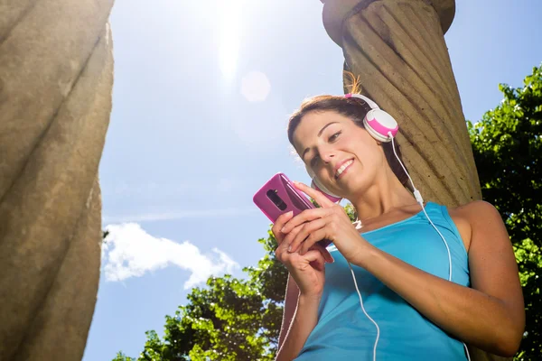 Fitness vrouw met smartphone en hoofdtelefoon — Stockfoto