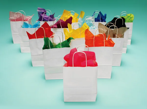 Белые сумки для покупок на зеленом — стоковое фото