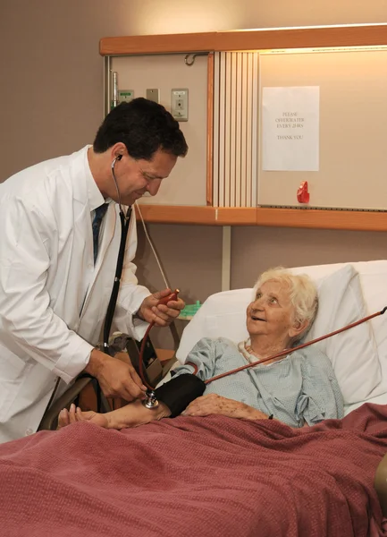 Arzt nimmt dem Senior den Blutdruck ab — Stockfoto