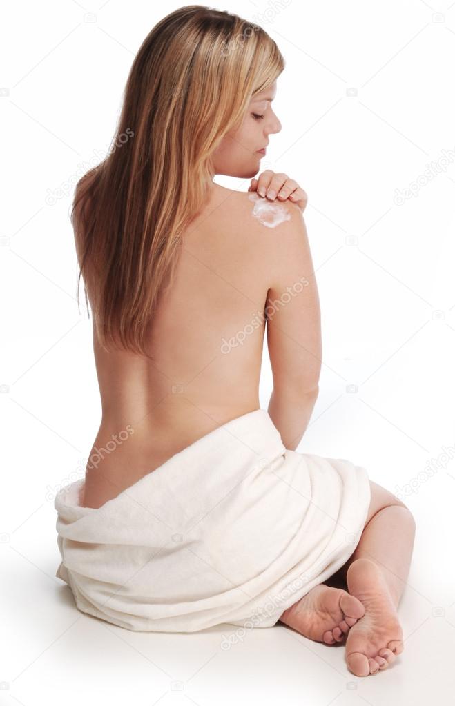 Applying lotion to shoulder