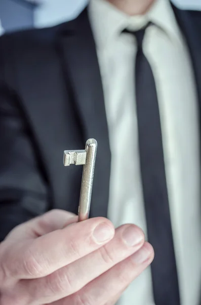 Man offering a key — Stock Photo, Image