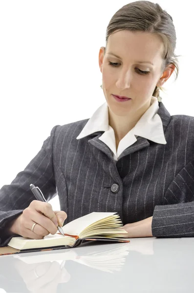 Zakenvrouw schrijven in haar Kladblok Stockfoto