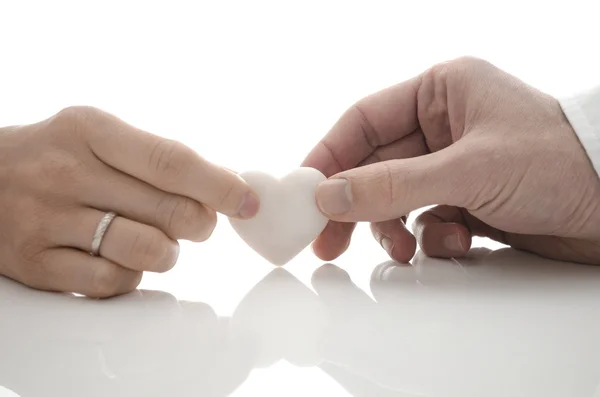 A man and a woman holding one heart — Stock Photo, Image