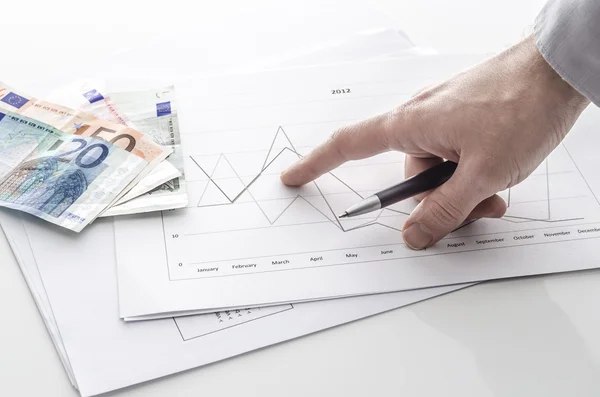 Man pointing at financial report — Stock Photo, Image