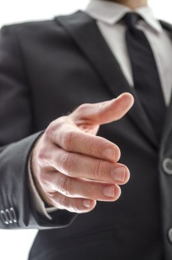 bir el sıkışma sunan iş adamı