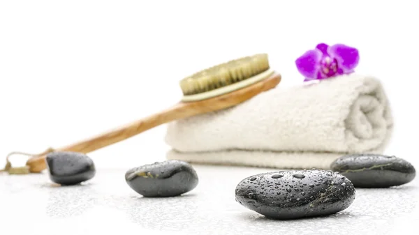 Spa setting with massage stones, brush and a towel — Stock Photo, Image