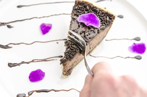 Eating a cake decorated with pink petal — Stock Photo, Image