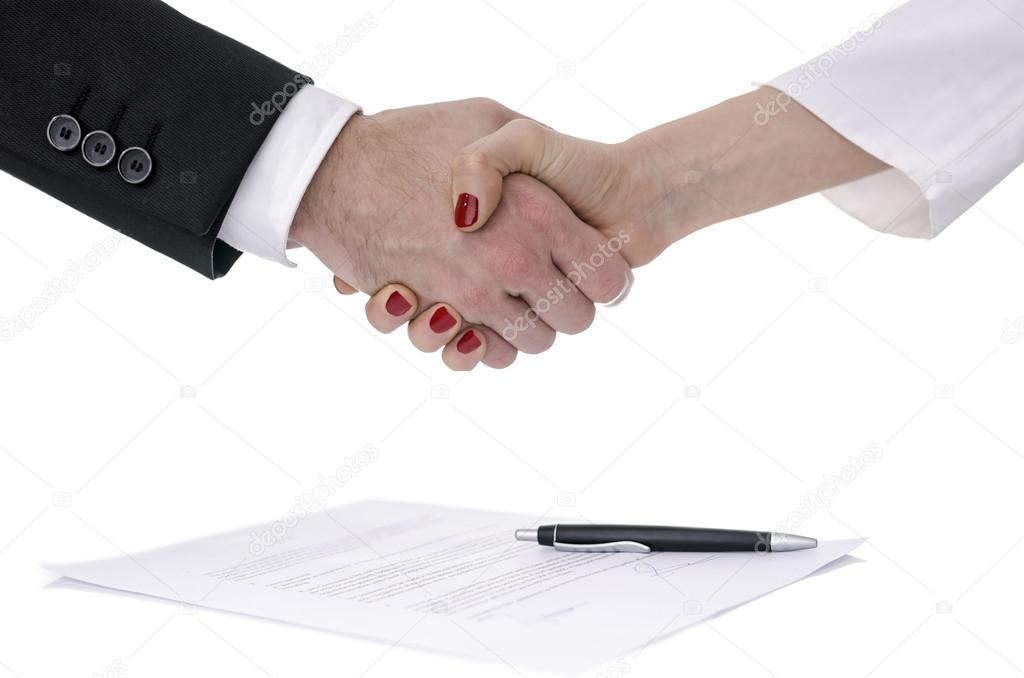 Man and woman shaking hands over a contract