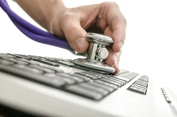 Testing a computer keyboard with stethoscope — Stock Photo, Image