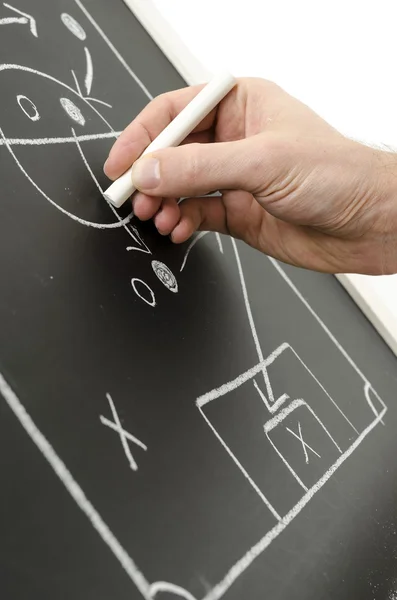 Mão escrevendo uma estratégia de fotball — Fotografia de Stock