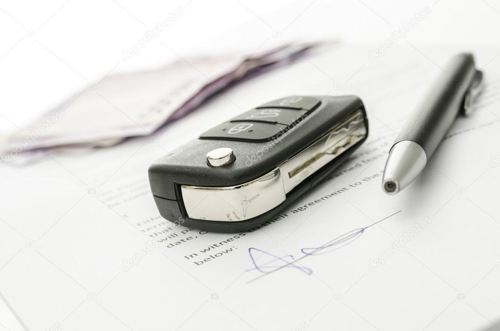 Car key on a contract of car sale