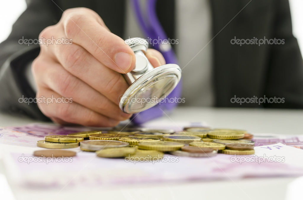 Businessman checking Euro money with stethoscope