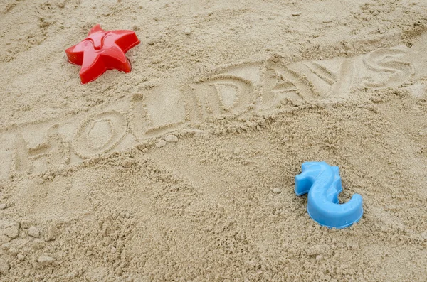 Vacaciones de palabras escritas en arena —  Fotos de Stock