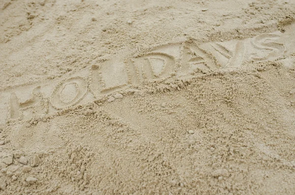 Palabra vacaciones escritas en la playa de arena —  Fotos de Stock