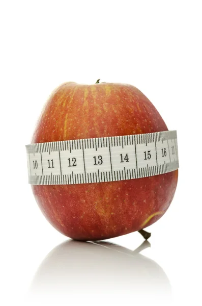 Measuring tape wrapped around apple — Stock Photo, Image