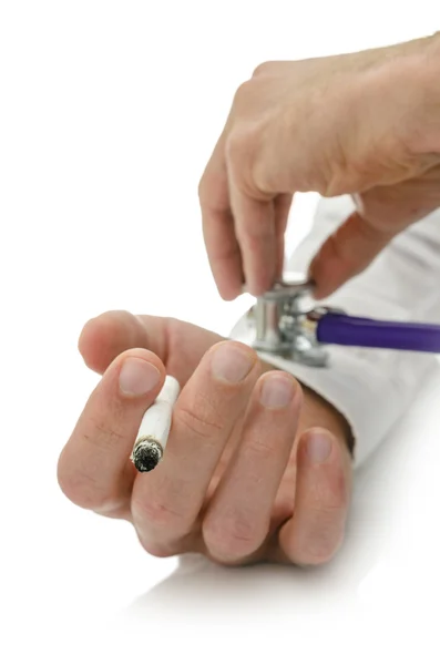 Holding stethoscope on cigarette addict hand — Stock Photo, Image