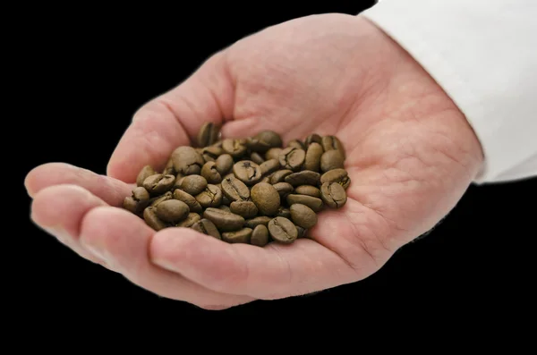 Coffee grains in male hand — Zdjęcie stockowe