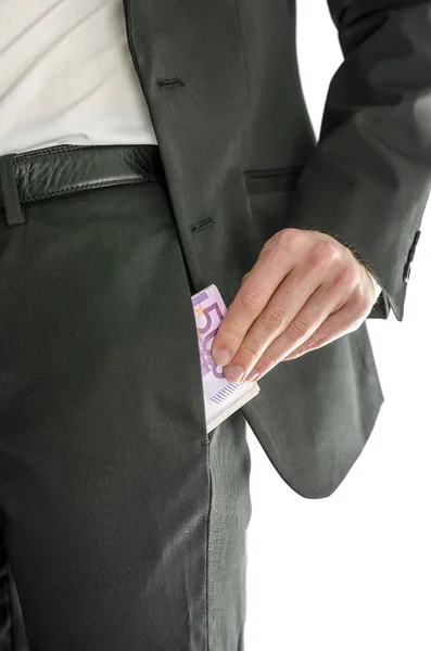 Front view of businessman putting money in his pocket — Stock Photo, Image